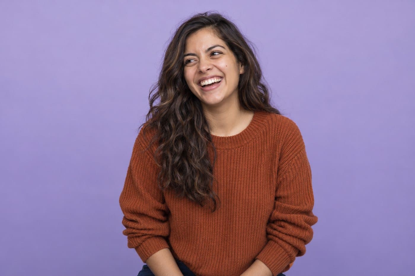Example of a match, a woman in a rust jumper, laughing.